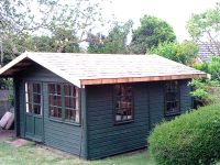 14 x 12 Summer Room with standard doors and windows. Cedar shingles are fitted to the roof - and the building has been painted by customer