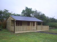 20x16 Pavilion with an additional 8x16 decking area. Fitted with a felt tile roof.