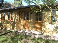 27 x 12 Studio style building, with a double recess, and garden office doors & windows. Internally fitted with a partition. 