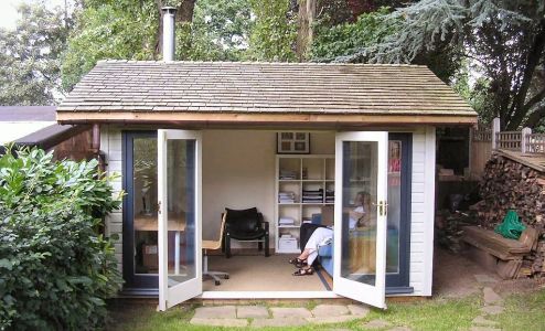 A beautiful bespoke Warwick Orchard Room. Customer choices include a Cedar Shingle roof, double glazed Contemporary double doors & sidelights, the cladding has been painted white with contrasting dark blue doors. The Customer added a log burner once the build was complete